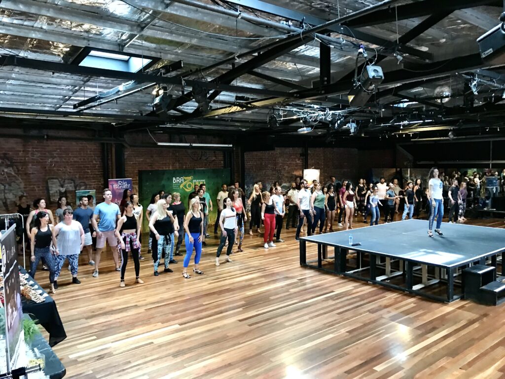 BraZouky workshop in The Space main hall with exposed brick walls and hardwood floor