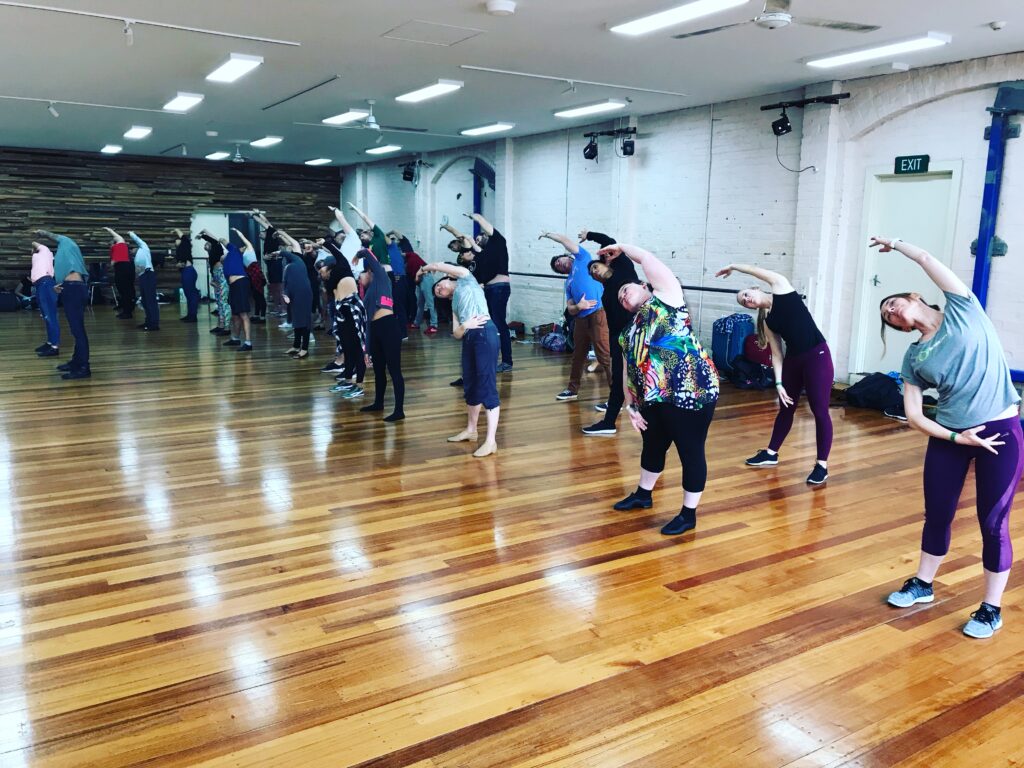 Warm-up stretches in a The Space dance studio with ballet barre